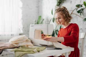 woman using sewing machine