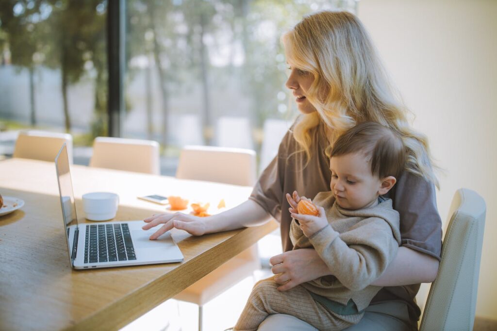 A mother working on her laptop with son 